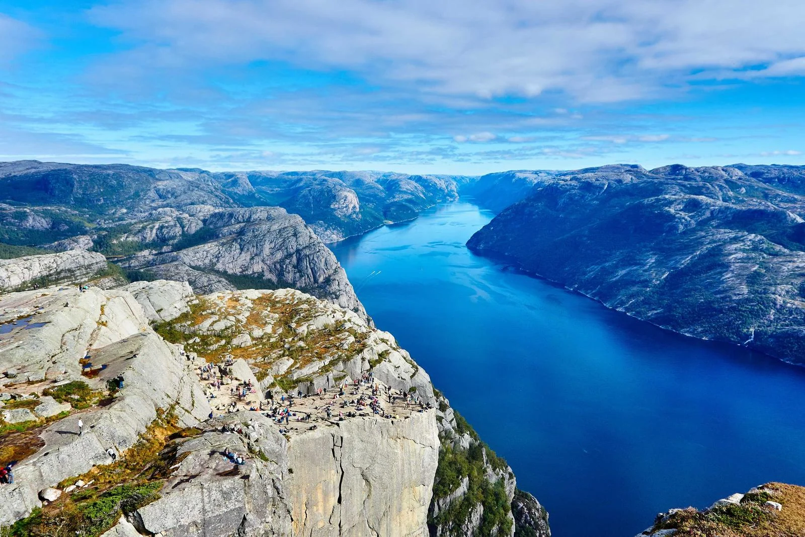 A blue fjord between steep rocky cliffs